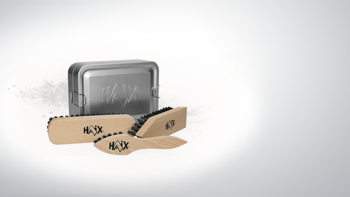 HAIX brush kit for boots featuring a silver metal tin and three wooden-handled brushes with black bristles, displayed on a clean white background.